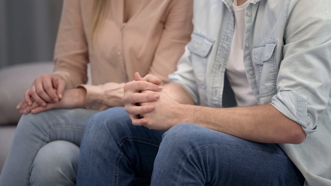 Couple sitting at psychologist, family crisis therapy, marriage counseling