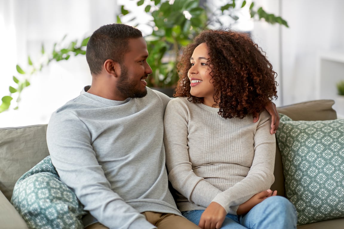 Young Couple Talking on Sofa at Home