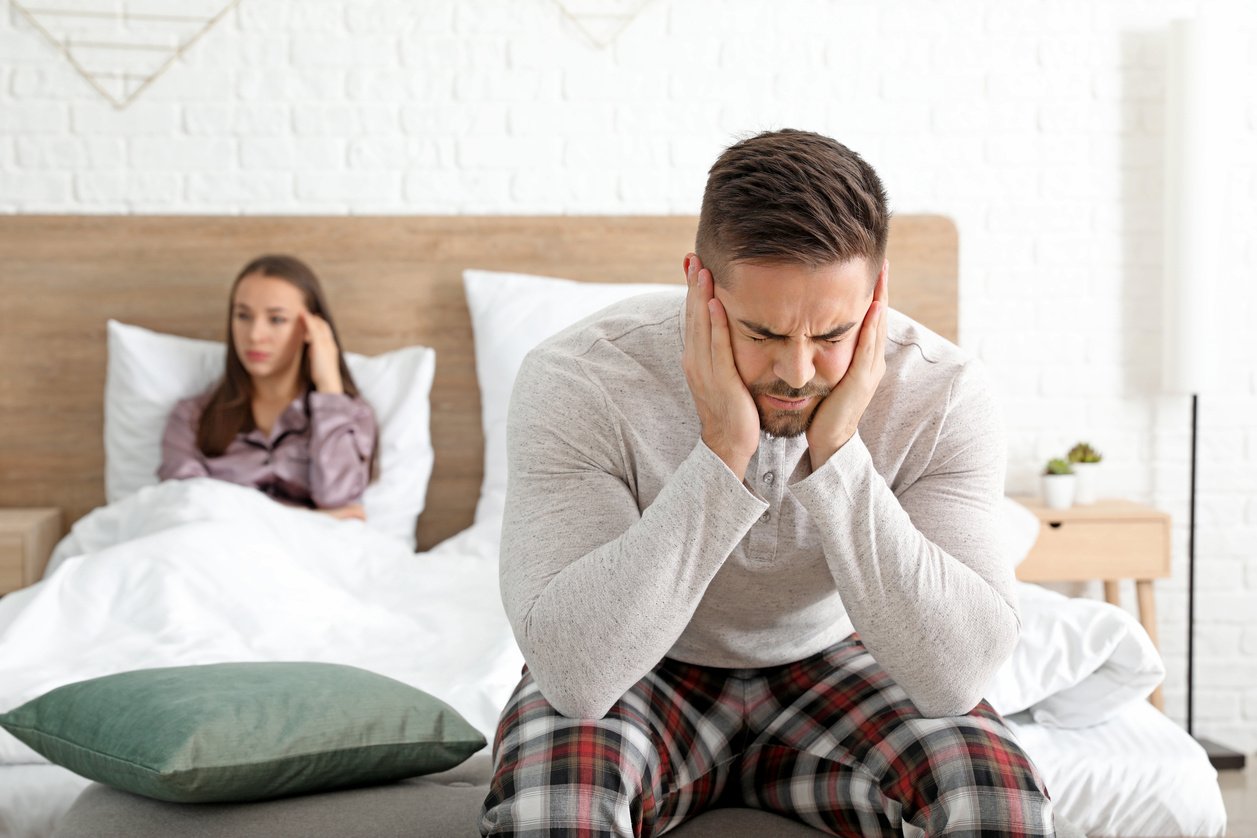 Sad Couple after Quarrel in Bedroom